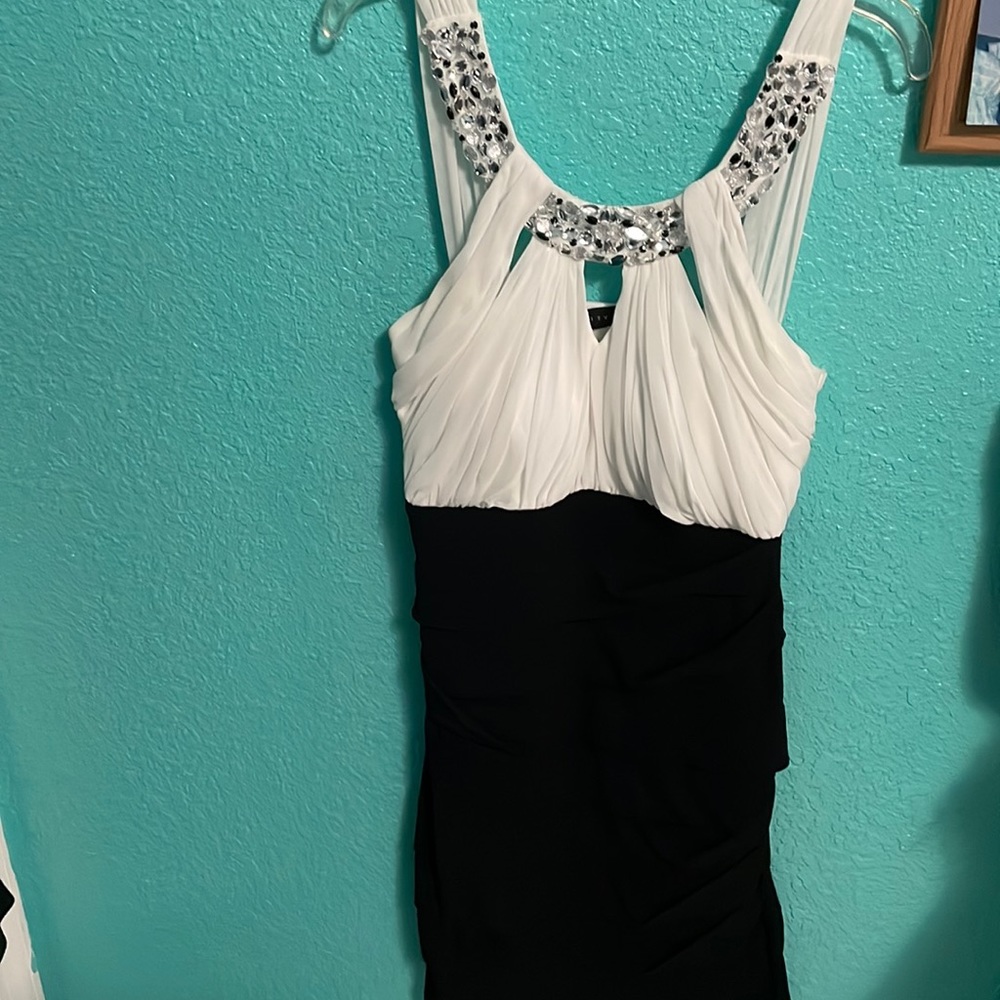 White and black mini dress with a studded silver beading along the neck line.